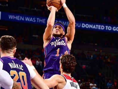 PHOENIX, AZ - DECEMBER 17: Devin Booker #1 of the Phoenix Suns shoots the ball during the game against the Washington Wizards on December 17, 2023 at Footprint Center in Phoenix, Arizona. NOTE TO USER: User expressly acknowledges and agrees that, by downloading and or using this photograph, user is consenting to the terms and conditions of the Getty Images License Agreement. Mandatory Copyright Notice: Copyright 2023 NBAE (Photo by Barry Gossage/NBAE via Getty Images)