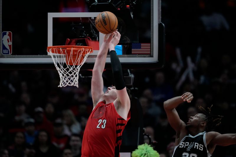 PORTLAND, OREGON - DECEMBER 13: Donovan Clingan #23 of the Portland Trail Blazers goes up for a dunk during the second half against the San Antonio Spurs at Moda Center on December 13, 2024 in Portland, Oregon. NOTE TO USER: User expressly acknowledges and agrees that, by downloading and or using this photograph, User is consenting to the terms and conditions of the Getty Images License Agreement. (Photo by Soobum Im/Getty Images)