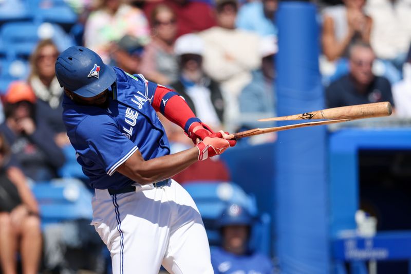 Mar 6, 2025; Dunedin, Florida, USA; Toronto Blue Jays first baseman Vladimir Guerrero Jr. (27) breaks his bat on a ground ball against the Boston Red Sox in the second inning during spring training at TD Ballpark. Mandatory Credit: Nathan Ray Seebeck-Imagn Images