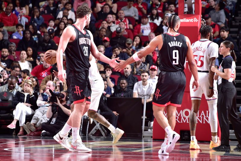 HOUSTON, TX - NOVEMBER 15: Alperen Sengun #28 and Dillon Brooks #9 of the Houston Rockets high five during the game against the LA Clippers during the Emirates NBA Cup game on November 15, 2024 at the Toyota Center in Houston, Texas. NOTE TO USER: User expressly acknowledges and agrees that, by downloading and or using this photograph, User is consenting to the terms and conditions of the Getty Images License Agreement. Mandatory Copyright Notice: Copyright 2024 NBAE (Photo by Logan Riely/NBAE via Getty Images)