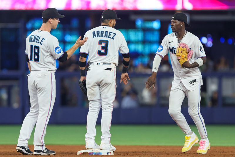 Aug 27, 2023; Miami, Florida, USA; Miami Marlins center fielder Jazz Chisholm Jr. (2) celebrates with second baseman Luis Arraez (3) and shortstop Joey Wendle (18) after winning the game against the Washington Nationals at loanDepot Park. Mandatory Credit: Sam Navarro-USA TODAY Sports