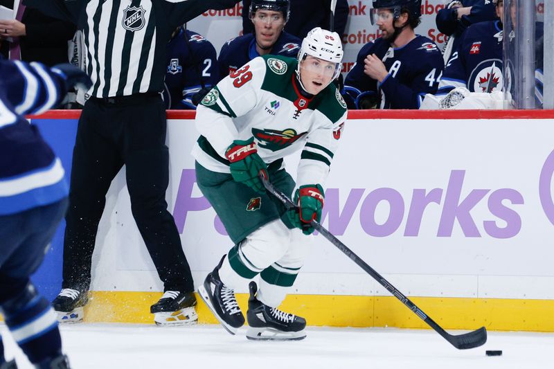 Nov 23, 2025; Winnipeg, Manitoba, CAN;  Minnesota Wild forward Ben Jones (39) skates into the Winnipeg Jets zone during the first period at Canada Life Centre. Mandatory Credit: Terrence Lee-Imagn Images