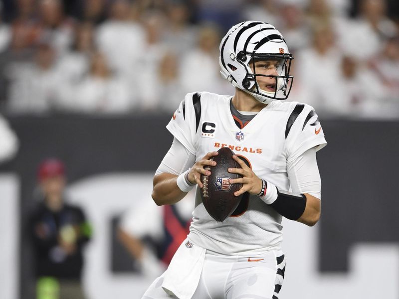 Cincinnati Bengals quarterback Joe Burrow (9) drops back to pass during an NFL football game against the Los Angeles Rams on Monday, Sept. 25, 2023, in Cincinnati. (AP Photo/Emilee Chinn)