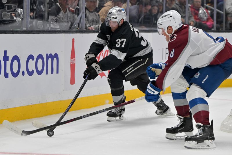 Oct 7, 2025; Los Angeles, California, USA;  Los Angeles Kings left wing Warren Foegele (37) and Colorado Avalanche defenseman Cale Makar (8) battle along the boards during the second period at Crypto.com Arena. Mandatory Credit: Jayne Kamin-Oncea-Imagn Images