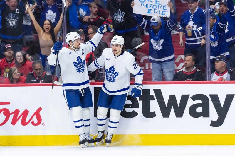 Apr 26, 2025; Ottawa, Ontario, CAN; Toronto Maple Leafscenter Auston Matthews (34) celebrates with left wing Matthew Knies (23) his goal scored in the second period against the Ottawa Senators in game four of the first round of the 2025 Stanley Cup Playoffs at Canadian Tire Centre. Mandatory Credit: Marc DesRosiers-Imagn Images