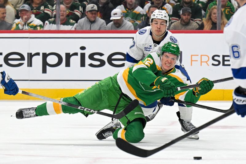 Mar 3, 2026; Saint Paul, Minnesota, USA;  Minnesota Wild forward Danila Yurov (22) is tied up by Tampa Bay Lightning forward Yanni Gourde (37) during the second period at Grand Casino Arena. Mandatory Credit: Nick Wosika-Imagn Images