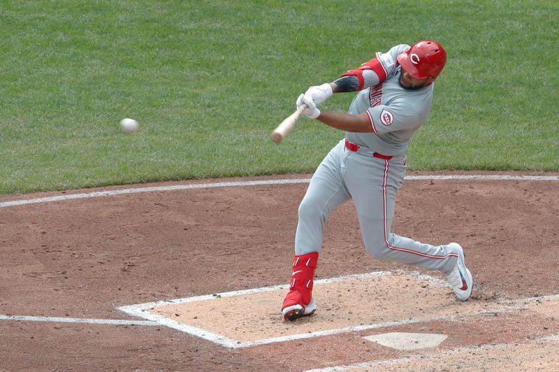 Aug 25, 2024; Pittsburgh, Pennsylvania, USA;  Cincinnati Reds first baseman Dominic Smith (0) hits a single against the Pittsburgh Pirates during the fourth inning at PNC Park. Mandatory Credit: Charles LeClaire-USA TODAY Sports