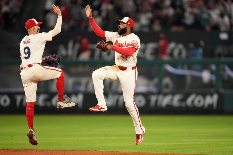 Jun 7, 2025; Anaheim, California, USA; Los Angeles Angels shortstop Zach Neto (9) and center fielder Jo Adell (7) celebrate at the end of the game against the Seattle Mariners at Angel Stadium. Mandatory Credit: Kirby Lee-Imagn Images