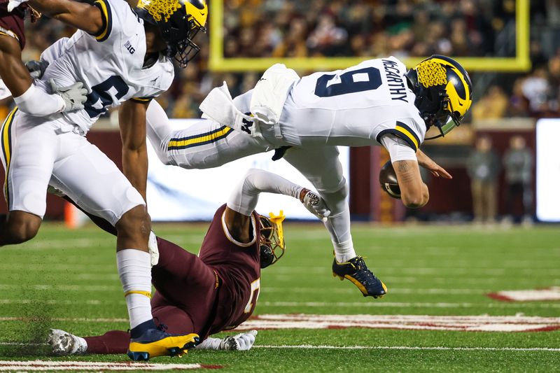 Oct 7, 2023; Minneapolis, Minnesota, USA; Michigan Wolverines quarterback J.J. McCarthy (9) runs the ball against the Minnesota Golden Gophers during the first quarter at Huntington Bank Stadium. Mandatory Credit: Matt Krohn-USA TODAY Sports