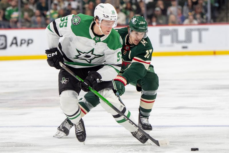 Apr 6, 2025; Saint Paul, Minnesota, USA; Dallas Stars defenseman Thomas Harley (55) steals the puck from Minnesota Wild left wing Marcus Foligno (17) in the second period at Xcel Energy Center. Mandatory Credit: Matt Blewett-Imagn Images