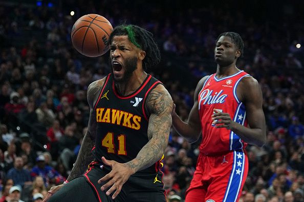 PHILADELPHIA, PENNSYLVANIA - DECEMBER 8: Saddiq Bey #41 of the Atlanta Hawks reacts in front of Mo Bamba #7 of the Philadelphia 76ers after dunk the ball in the fourth quarter at the Wells Fargo Center on December 8, 2023 in Philadelphia, Pennsylvania. The 76ers defeated the Hawks 125-114. NOTE TO USER: User expressly acknowledges and agrees that, by downloading and or using this photograph, User is consenting to the terms and conditions of the Getty Images License Agreement. (Photo by Mitchell Leff/Getty Images)