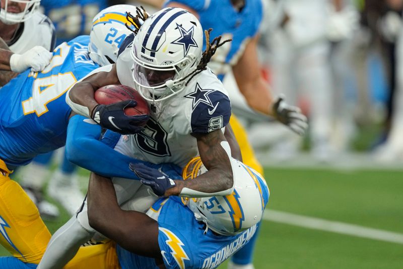 Dallas Cowboys wide receiver KaVontae Turpin (9) is tackled on a kickoff return by Los Angeles Chargers safety AJ Finley (24) and Los Angeles Chargers linebacker Amen Ogbongbemiga (57) during the first half of an NFL football game Monday, Oct. 16, 2023, in Inglewood, Calif. (AP Photo/Mark J. Terrill)