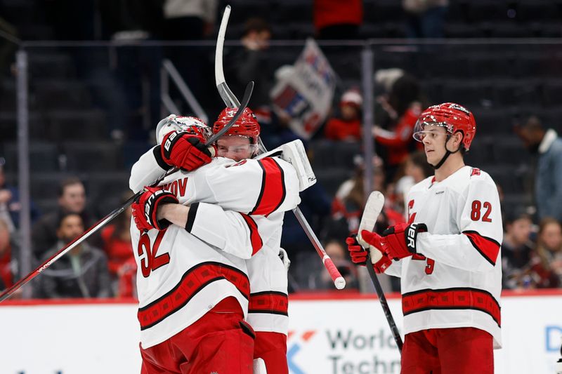 Jan 5, 2024; Washington, District of Columbia, USA; Carolina Hurricanes goaltender Pyotr Kochetkov (52) celebrates with Hurricanes right wing Andrei Svechnikov (37) after their game against the Washington Capitals at Capital One Arena. Mandatory Credit: Geoff Burke-USA TODAY Sports