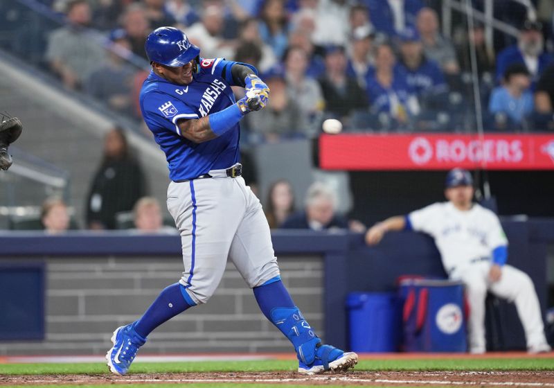 May 1, 2024; Toronto, Ontario, CAN; Kansas City Royals catcher Salvador Perez (13) hits an RBI single against the Toronto Blue Jays during the sixth inning at Rogers Centre. Mandatory Credit: Nick Turchiaro-USA TODAY Sports