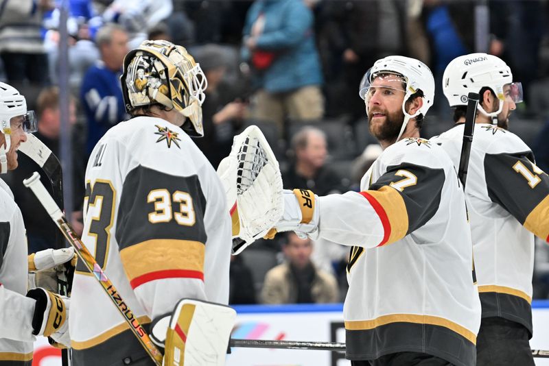 Feb 27, 2024; Toronto, Ontario, CAN;  Vegas Golden Knights defenseman Alex Pietrangelo (7) bumps gloves with goalie Adin Hill (33) as they celebrate a win over the Toronto Maple Leafs at Scotiabank Arena. Mandatory Credit: Dan Hamilton-USA TODAY Sports