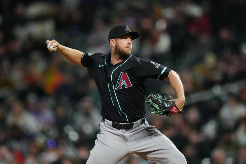 Apr 9, 2024; Denver, Colorado, USA; Arizona Diamondbacks starting pitcher Merrill Kelly (29) delivers a pitch in the fifth inning against the Colorado Rockies at Coors Field. Mandatory Credit: Ron Chenoy-USA TODAY Sports