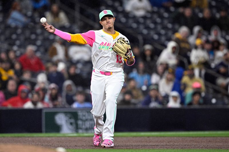 Apr 26, 2024; San Diego, California, USA; San Diego Padres third baseman Manny Machado (13) throws to first base on a ground out by Philadelphia Phillies right fielder Nick Castellanos (not pictured) during the ninth inning at Petco Park. Mandatory Credit: Orlando Ramirez-USA TODAY Sports