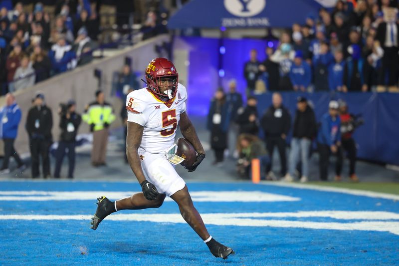 Nov 11, 2023; Provo, Utah, USA; Iowa State Cyclones running back Cartevious Norton (5) scores a touchdown against the Brigham Young Cougars in the second quarter at LaVell Edwards Stadium. Mandatory Credit: Rob Gray-USA TODAY Sports