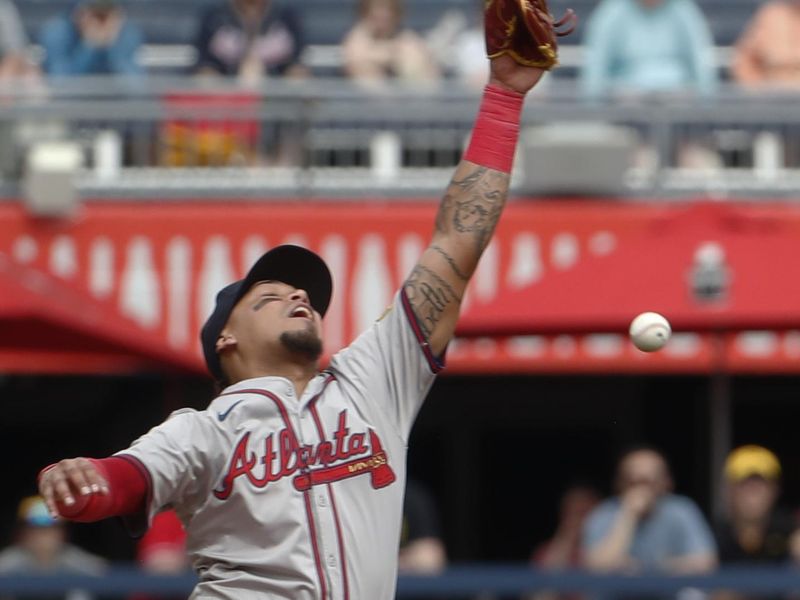 May 26, 2024; Pittsburgh, Pennsylvania, USA;  Atlanta Braves shortstop Orlando Arcia (11) leaps but can not catch a ball hit for a single by Pittsburgh Pirates first baseman Connor Joe (not pictured) during the ninth inning at PNC Park. Atlanta won 8-1. Mandatory Credit: Charles LeClaire-USA TODAY Sports