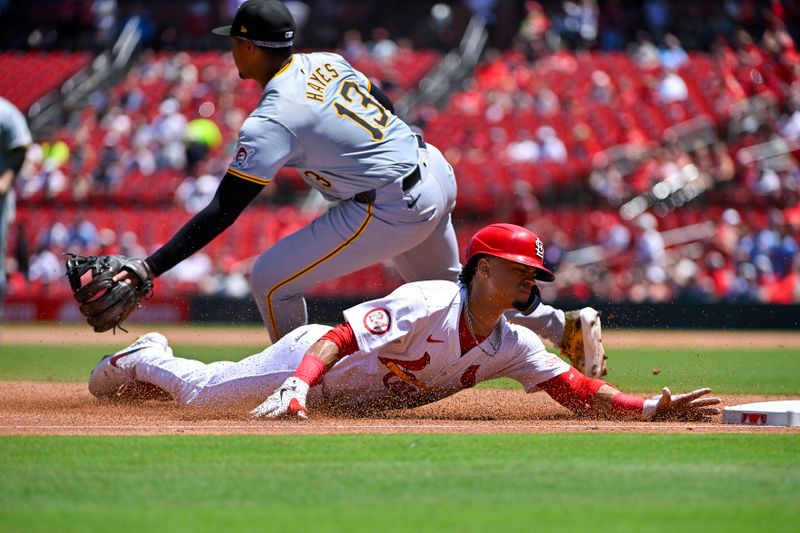 Jun 13, 2024; St. Louis, Missouri, USA;  St. Louis Cardinals shortstop Masyn Winn (0) slides past Pittsburgh Pirates third baseman Ke'Bryan Hayes (13) for a triple during the third inning at Busch Stadium. Mandatory Credit: Jeff Curry-USA TODAY Sports