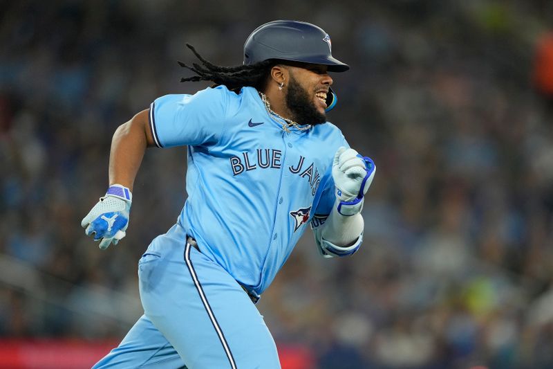 Apr 28, 2024; Toronto, Ontario, CAN; Toronto Blue Jays designated hitter Vladimir Guerrero Jr. (27) runs to first base on a single against the Los Angeles Dodgers during the first inning at Rogers Centre. Mandatory Credit: John E. Sokolowski-USA TODAY Sports