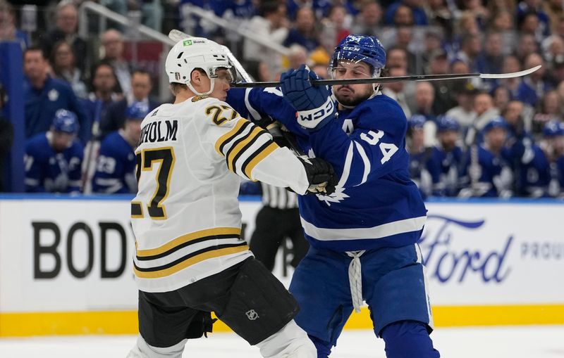 Apr 24, 2024; Toronto, Ontario, CAN; Toronto Maple Leafs forward Auston Matthews (34) and Boston Bruins defenseman Hampus Lindholm (27) battle for position during the first period of game three of the first round of the 2024 Stanley Cup Playoffs at Scotiabank Arena. Mandatory Credit: John E. Sokolowski-USA TODAY Sports