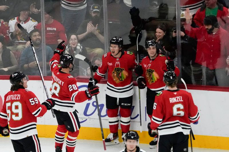 Oct 28, 2025; Chicago, Illinois, USA; Chicago Blackhawks center Connor Bedard, (center) celebrates his goal against the Ottawa Senators with his teammates during the first period at United Center. Mandatory Credit: David Banks-Imagn Images