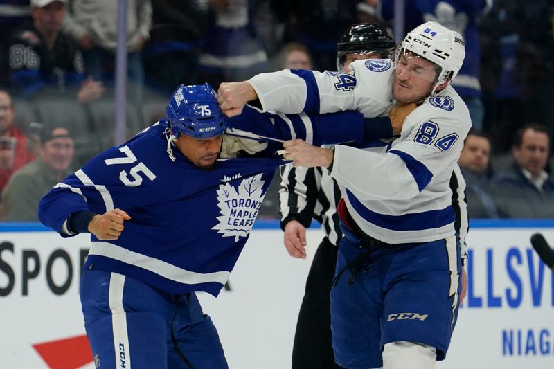 Apr 3, 2024; Toronto, Ontario, CAN; Tampa Bay Lightning forward Tanner Jeannot (84) lands a punch on Toronto Maple Leafs forward Ryan Reaves (75) during a fight in the third period at Scotiabank Arena. Mandatory Credit: John E. Sokolowski-USA TODAY Sports