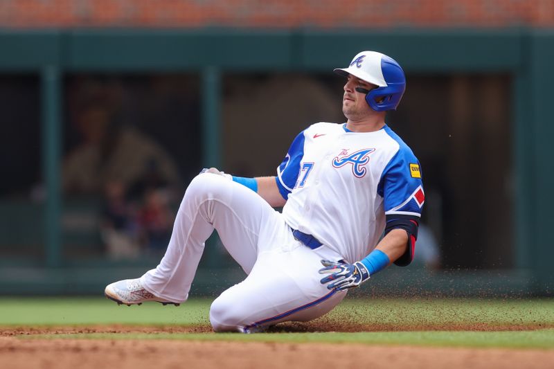 May 24, 2025; Atlanta, Georgia, USA; Atlanta Braves third baseman Austin Riley (27) slides in safely with a double against the San Diego Padres in the third inning at Truist Park. Mandatory Credit: Brett Davis-Imagn Images