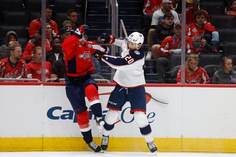 Sep 27, 2024; Washington, District of Columbia, USA; Columbus Blue Jackets forward Curtis Hall (20) checks Washington Capitals defenseman Alexander Alexeyev (27) in the second period at Capital One Arena. Mandatory Credit: Geoff Burke-Imagn Images