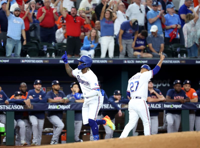 Oct 19, 2023; Arlington, Texas, USA; Texas Rangers right fielder Adolis Garcia (53) celebrates with third base coach Tony Beasley (27) after hitting a solo home run during the second inning in game four of the ALCS against the Houston Astros for the 2023 MLB playoffs at Globe Life Field. Mandatory Credit: Andrew Dieb-USA TODAY Sports