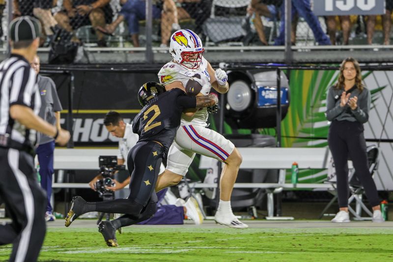 Oct 4, 2025; Orlando, Florida, USA; Kansas Jayhawks tight end Boden Groen (88) is tackled by UCF Knights defensive back Phillip Dunnam (2) during the second quarter at FBC Mortgage Stadium. Mandatory Credit: Mike Watters-Imagn Images