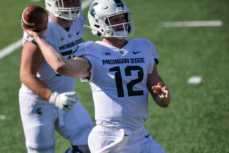 Nov 7, 2020; Iowa City, Iowa, USA; Michigan State Spartans quarterback Rocky Lombardi (12) throws a pass during the first quarter against the Iowa Hawkeyes at Kinnick Stadium. Mandatory Credit: Jeffrey Becker-USA TODAY Sports