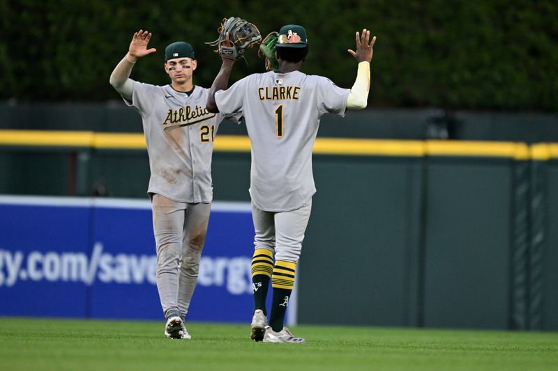 Jun 25, 2025; Detroit, Michigan, USA; Athletics left fielder Tyler Soderstrom (21) and center fielder Denzel Clarke (1) celebrate in the outfield after defeating the Detroit Tigers at Comerica Park. Mandatory Credit: Lon Horwedel-Imagn Images