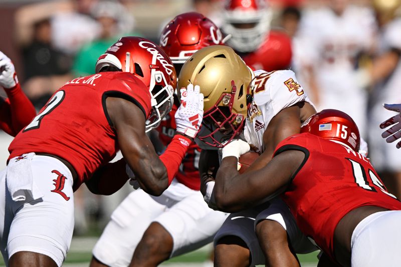 Sep 23, 2023; Louisville, Kentucky, USA; Louisville Cardinals defensive back Jarvis Brownlee Jr. (2) and  defensive lineman Kameron Wilson (15) tackle Boston College Eagles running back Alex Broome (20) during the first half at L&N Federal Credit Union Stadium. Mandatory Credit: Jamie Rhodes-USA TODAY Sports