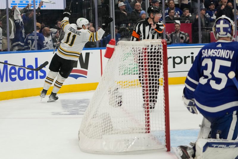 Apr 24, 2024; Toronto, Ontario, CAN; Boston Bruins forward Trent Frederic (11) celebrates his goal against Toronto Maple Leafs goaltender Ilya Samsonov (35) during the second period of game three of the first round of the 2024 Stanley Cup Playoffs at Scotiabank Arena. Mandatory Credit: John E. Sokolowski-USA TODAY Sports