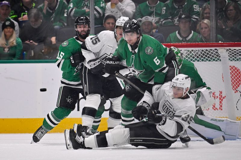 Oct 23, 2025; Dallas, Texas, USA; Los Angeles Kings center Alex Turcotte (15) and left wing Jeff Malott (39) and Dallas Stars center Colin Blackwell (15) and defenseman Lian Bichsel (6) look for the puck during the second period at the American Airlines Center. Mandatory Credit: Jerome Miron-Imagn Images