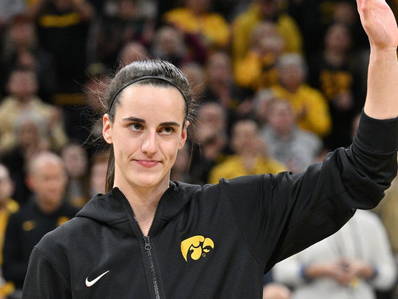 Feb 8, 2024; Iowa City, Iowa, USA; Iowa Hawkeyes guard Caitlin Clark (22) accepts the award as the Big Ten's All-Time scoring leader in women's basketball before the game against the Penn State Nittany Lions at Carver-Hawkeye Arena. Mandatory Credit: Jeffrey Becker-USA TODAY Sports