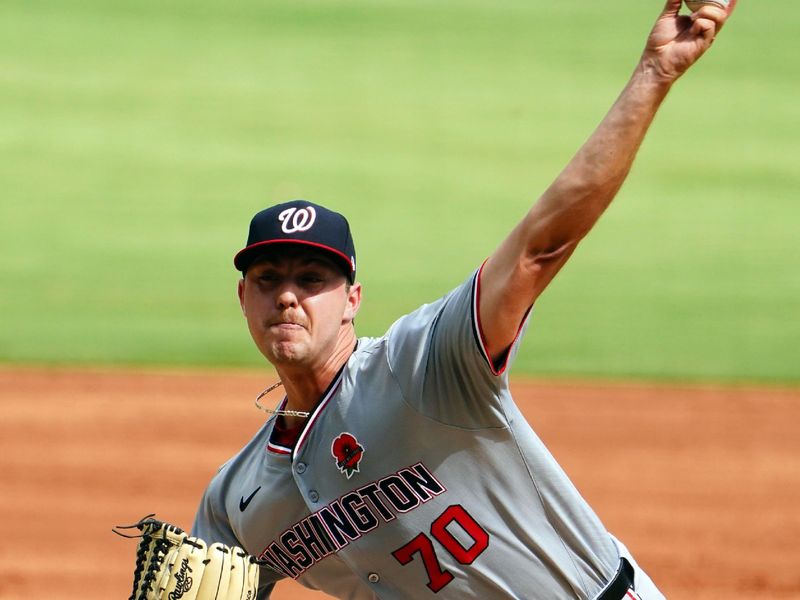 May 27, 2024; Cumberland, Georgia, USA; Washington Nationals pitcher Mitchell Parker (70) fires off a pitch against the Atlanta Braves during the first inning at Truist Park. Mandatory Credit: John David Mercer-USA TODAY Sports