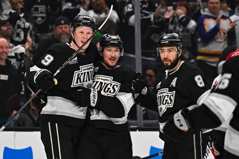 Mar 22, 2025; Los Angeles, California, USA; Los Angeles Kings defenseman Brandt Clarke (92), left wing Trevor Moore (12), and defenseman Drew Doughty (8) celebrate after scoring against the Carolina Hurricanes during the second period at Crypto.com Arena. Mandatory Credit: Jonathan Hui-Imagn Images