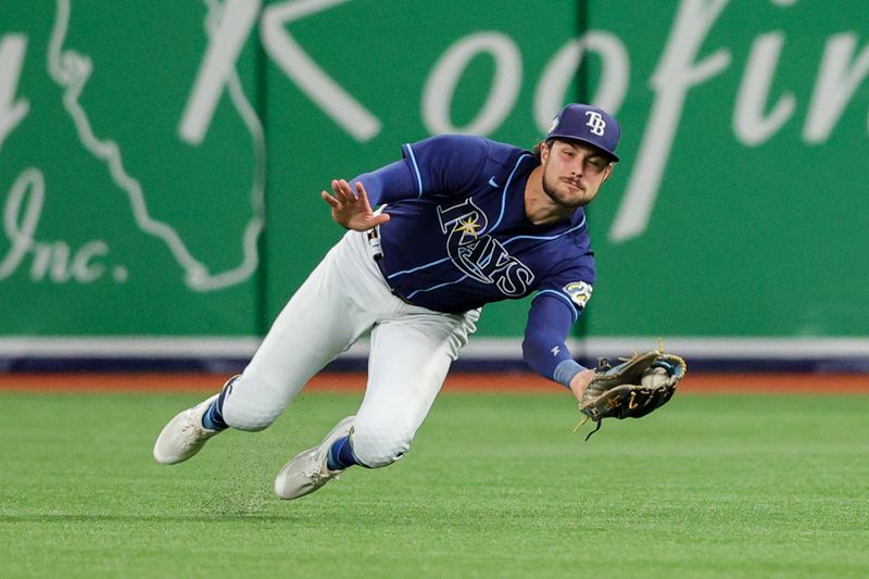    Sep 7, 2023; St. Petersburg, Florida, USA;  Tampa Bay Rays right fielder Josh Lowe (15) make a diving catch against the Seattle Mariners in the fifth inning at Tropicana Field. Mandatory Credit: Nathan Ray Seebeck-USA TODAY Sports