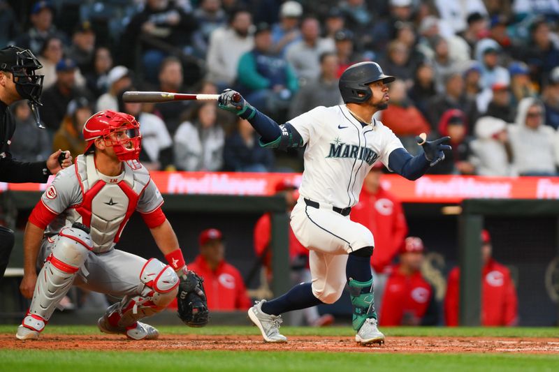 Apr 16, 2024; Seattle, Washington, USA; Seattle Mariners left fielder Jonatan Clase (5) hits an RBI double against the Cincinnati Reds during the fourth inning at T-Mobile Park. Mandatory Credit: Steven Bisig-USA TODAY Sports