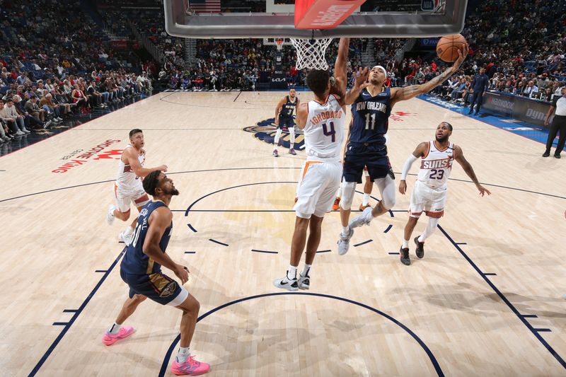 NEW ORLEANS, LA - DECEMBER 5: Jalen Crutcher #11 of the New Orleans Pelicans drives to the basket during the game against the Phoenix Suns on December 5, 2024 at the Smoothie King Center in New Orleans, Louisiana. NOTE TO USER: User expressly acknowledges and agrees that, by downloading and or using this Photograph, user is consenting to the terms and conditions of the Getty Images License Agreement. Mandatory Copyright Notice: Copyright 2024 NBAE (Photo by Layne Murdoch Jr./NBAE via Getty Images)