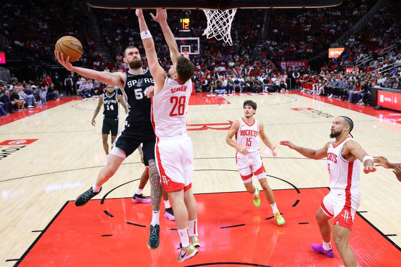 HOUSTON, TEXAS - OCTOBER 17: Sandro Mamukelashvili #54 of the San Antonio Spurs shoots against Alperen Sengun #28 of the Houston Rockets during the second half of a preseason game at Toyota Center on October 17, 2024 in Houston, Texas. NOTE TO USER: User expressly acknowledges and agrees that, by downloading and or using this photograph, User is consenting to the terms and conditions of the Getty Images License Agreement. (Photo by Alex Slitz/Getty Images)