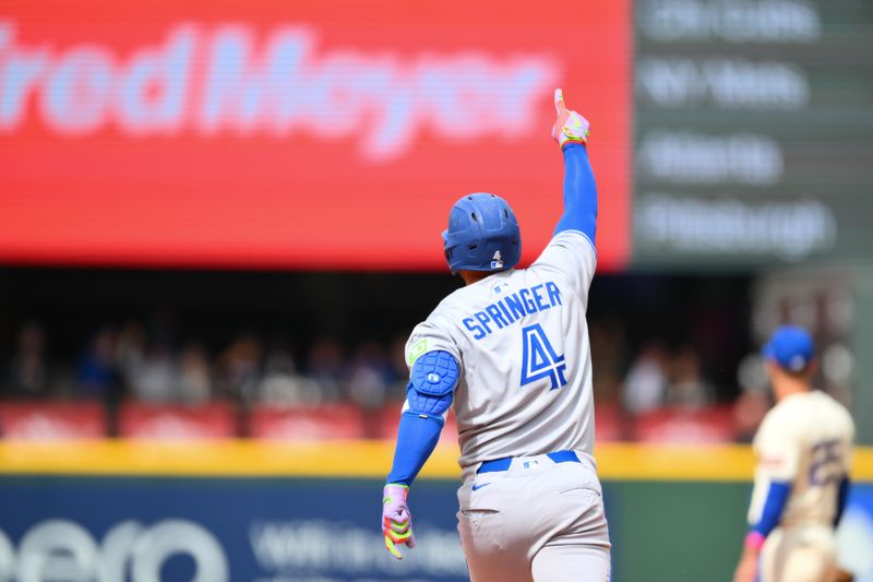 May 11, 2025; Seattle, Washington, USA; Toronto Blue Jays designated hitter George Springer (4) runs the bases after hitting a 3-run home run against the Seattle Mariners during the fifth inning at T-Mobile Park. Mandatory Credit: Steven Bisig-Imagn Images