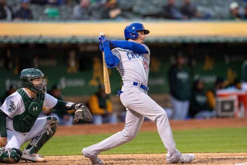 Apr 17, 2023; Oakland, California, USA;  Chicago Cubs center fielder Cody Bellinger (24) hits a double against the Oakland Athletics during the fourth inning at RingCentral Coliseum. Mandatory Credit: Neville E. Guard-USA TODAY Sports