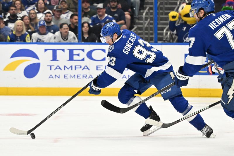 Feb 25, 2025; Tampa, Florida, USA; Tampa Bay Lightning center Gage Goncalves (93) chases down the puck  in the second period against the Edmonton Oilers at Amalie Arena. Mandatory Credit: Jonathan Dyer-Imagn Images