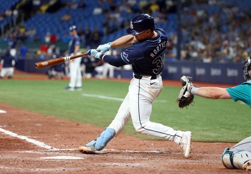 Jun 25, 2024; St. Petersburg, Florida, USA; Tampa Bay Rays catcher Ben Rortvedt (30) hits a two RBI single against the Seattle Mariners during the seventh inning at Tropicana Field. Mandatory Credit: Kim Klement Neitzel-USA TODAY Sports