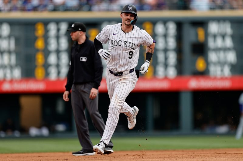 Jun 18, 2024; Denver, Colorado, USA; Colorado Rockies center fielder Brenton Doyle (9) rounds the baes on a solo home run in the fourth inning against the Los Angeles Dodgers at Coors Field. Mandatory Credit: Isaiah J. Downing-USA TODAY Sports