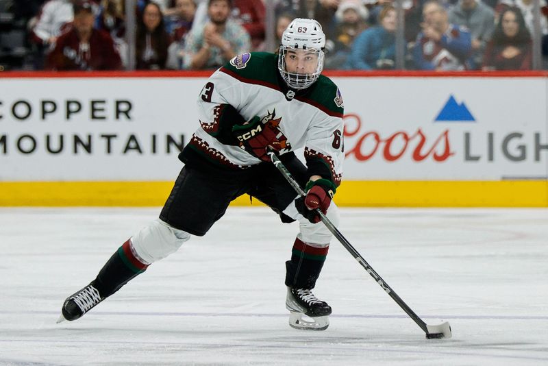 Dec 23, 2023; Denver, Colorado, USA; Arizona Coyotes left wing Matias Maccelli (63) controls the puck in the first period against the Colorado Avalanche at Ball Arena. Mandatory Credit: Isaiah J. Downing-USA TODAY Sports